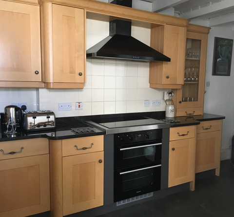 Kitchen with electric cooker and hob